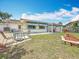 A view of the well-manicured lawn, shaded patio, and fenced yard at 6350 18Th N Ave, St Petersburg, FL 33710