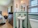 This bathroom features classic green and white tilework, a pedestal sink, and an updated toilet at 6350 18Th N Ave, St Petersburg, FL 33710