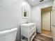 Bathroom featuring a toilet, and white vanity with mirror and wood-look flooring at 6350 18Th N Ave, St Petersburg, FL 33710