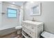 Bright bathroom featuring a tub, white vanity with mirror, and wood-look flooring at 6350 18Th N Ave, St Petersburg, FL 33710