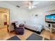 Comfortable bedroom featuring wood floors, a ceiling fan, and a cozy recliner for relaxation at 6350 18Th N Ave, St Petersburg, FL 33710