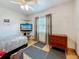 Inviting bedroom with wood floors, a ceiling fan, and a built-in media center with a television at 6350 18Th N Ave, St Petersburg, FL 33710
