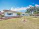 Beautiful home showcasing new driveway, gray roof, stone accents, fresh landscaping, and a manicured lawn at 6350 18Th N Ave, St Petersburg, FL 33710