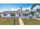 Charming single-story home with well-manicured lawn, stone accents, and beautiful blue shutters on a bright, sunny day at 6350 18Th N Ave, St Petersburg, FL 33710