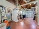 A disheveled garage featuring exposed ceiling with hanging lights and tools at 6350 18Th N Ave, St Petersburg, FL 33710