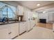 Well-maintained kitchen with white cabinets, dishwasher, and easy access to adjacent room at 6350 18Th N Ave, St Petersburg, FL 33710