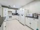 Spacious kitchen featuring white cabinets, tile floors, and modern appliances at 6350 18Th N Ave, St Petersburg, FL 33710