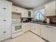 Well-lit kitchen with white cabinets, tile backsplash, and stainless steel sink at 6350 18Th N Ave, St Petersburg, FL 33710