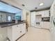 Charming kitchen with white cabinets, a view into the living area, and tiled backsplash at 6350 18Th N Ave, St Petersburg, FL 33710