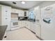 Functional kitchen with white appliances and convenient access to dining and living areas at 6350 18Th N Ave, St Petersburg, FL 33710