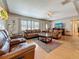 Bright living room featuring hardwood floors, neutral paint, updated ceiling fan and a decorative front door at 6350 18Th N Ave, St Petersburg, FL 33710