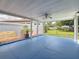 Covered patio with blue flooring, ceiling fan, and view of the fenced backyard at 6350 18Th N Ave, St Petersburg, FL 33710