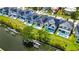 Aerial view of waterfront homes with pools and canal access, and wooden docks at 6532 Simone Shores Cir, Apollo Beach, FL 33572