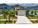A high angle of the property showing its tidy landscaping, driveway, and roof at 6532 Simone Shores Cir, Apollo Beach, FL 33572