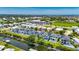 Aerial view of modern waterfront homes with pools and canal access, showcasing the community's layout and nearby commerce at 6532 Simone Shores Cir, Apollo Beach, FL 33572