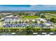 Aerial view of a waterfront community featuring modern homes, pools, and canal access near commercial areas at 6532 Simone Shores Cir, Apollo Beach, FL 33572