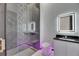 Modern bathroom featuring a sleek glass shower, designer tiles and LED lighting at 6532 Simone Shores Cir, Apollo Beach, FL 33572
