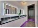 Elegant bathroom with double vanity, walk-in shower, and violet LED accent lighting at 6532 Simone Shores Cir, Apollo Beach, FL 33572