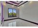 Bright bedroom featuring modern lighting, sleek floors, and a large window with a serene view at 6532 Simone Shores Cir, Apollo Beach, FL 33572