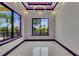Bright bedroom featuring modern lighting, sleek tile floors, and a beautiful view from the windows at 6532 Simone Shores Cir, Apollo Beach, FL 33572