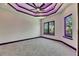 Elegant bedroom featuring a modern ceiling design with recessed lighting and violet LED accent lighting at 6532 Simone Shores Cir, Apollo Beach, FL 33572