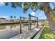 Picturesque waterfront view featuring a private boat dock on a tranquil canal, perfect for boating enthusiasts at 6532 Simone Shores Cir, Apollo Beach, FL 33572