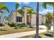 Inviting home exterior showcasing modern architecture, lush landscaping, and a well-manicured lawn at 6532 Simone Shores Cir, Apollo Beach, FL 33572
