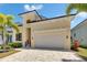 Elegant home features a spacious garage, stylish architecture, and well-maintained landscaping at 6532 Simone Shores Cir, Apollo Beach, FL 33572