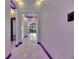 Contemporary hallway with sleek marble flooring and modern lighting at 6532 Simone Shores Cir, Apollo Beach, FL 33572