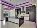 Modern kitchen with sleek black and white cabinetry, quartz countertops, stainless steel appliances, and marble flooring at 6532 Simone Shores Cir, Apollo Beach, FL 33572