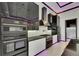 Close up of kitchen featuring built-in stainless steel oven, microwave, and range hood at 6532 Simone Shores Cir, Apollo Beach, FL 33572