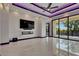 Contemporary living room with a sleek fireplace and sliding glass doors to a balcony with a view at 6532 Simone Shores Cir, Apollo Beach, FL 33572