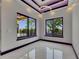 Bright living room featuring marble floors, modern recessed lighting, accent lighting, and large windows overlooking the backyard at 6532 Simone Shores Cir, Apollo Beach, FL 33572