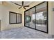 Covered patio with tile flooring, ceiling fan, and sliding glass doors, offering a seamless indoor-outdoor living experience at 6532 Simone Shores Cir, Apollo Beach, FL 33572