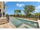 Backyard pool with a modern spa, stone patio, and lush landscaping, providing a relaxing outdoor retreat at 6532 Simone Shores Cir, Apollo Beach, FL 33572