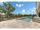 Beautiful backyard pool area featuring a modern pool design, tiled patio, and lush landscaping for relaxation and recreation at 6532 Simone Shores Cir, Apollo Beach, FL 33572