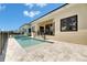Luxury home with a modern pool, tiled deck, and manicured lawn for the perfect outdoor relaxation and entertainment at 6532 Simone Shores Cir, Apollo Beach, FL 33572