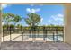 Gated pool area featuring a paved deck, lush greenery, and clear blue skies offering a secure and inviting space at 6532 Simone Shores Cir, Apollo Beach, FL 33572
