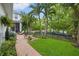 Spacious backyard patio with lounge chairs, grill, and mature landscaping creating a serene outdoor retreat at 702 34Th N Ave, St Petersburg, FL 33704