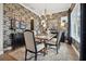 Elegant dining room with stylish wallpaper, chandelier, and a large table for gatherings at 702 34Th N Ave, St Petersburg, FL 33704