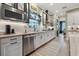 Stylish kitchen with modern appliances, white cabinets, and a view into the dining area at 702 34Th N Ave, St Petersburg, FL 33704