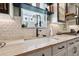 Modern kitchen boasts marble counters, sleek cabinetry, and stylish backsplash, offering an elegant cooking space at 702 34Th N Ave, St Petersburg, FL 33704