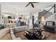 Bright and open living room featuring stylish seating, a modern staircase, and view to the kitchen at 702 34Th N Ave, St Petersburg, FL 33704