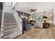 Open-concept living room featuring a staircase, comfortable seating, and an entertainment area at 702 34Th N Ave, St Petersburg, FL 33704