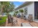A inviting brick patio area with comfortable seating, outdoor grill, and mature landscaping for relaxation at 702 34Th N Ave, St Petersburg, FL 33704