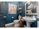 Chic powder room with stylish blue walls, modern fixtures, and decorative accents at 702 34Th N Ave, St Petersburg, FL 33704
