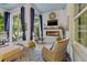Cozy sunroom with a brick fireplace, comfortable seating, and ample natural light, perfect for relaxation at 702 34Th N Ave, St Petersburg, FL 33704