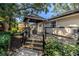 Landscaped backyard with a deck and gazebo for a peaceful retreat at 7461 Pescador Pl, Seminole, FL 33772