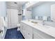 Updated bathroom features a double vanity, sleek fixtures, and stylish blue tiling at 7461 Pescador Pl, Seminole, FL 33772