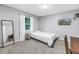 Cozy bedroom featuring neutral tones, natural light, and a wall-mounted TV at 7461 Pescador Pl, Seminole, FL 33772